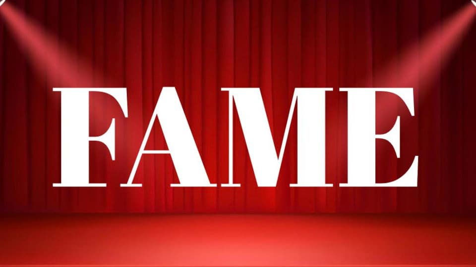 Red stage curtains with white text over the top reading 'Fame'.